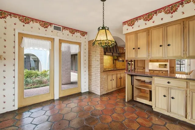 a open kitchen with white cabinets and window