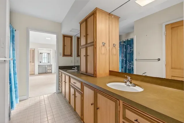 a bathroom with a sink double vanity and a mirror