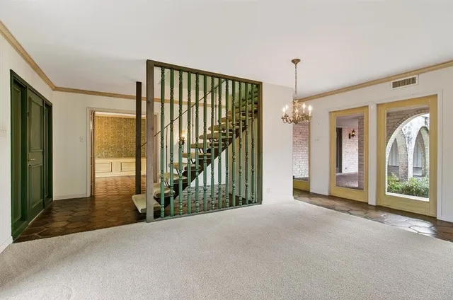 a view of a hallway with wooden floor and windows