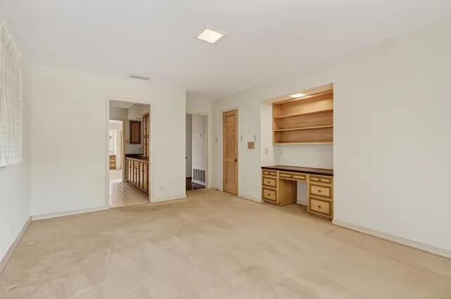 a view of a kitchen with refrigerator and cabinet