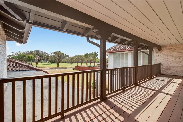 a view of balcony with wooden floor