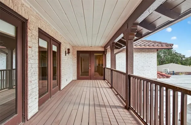 a view of a balcony with wooden floor