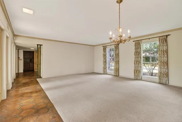 a view of a room with window and chandelier