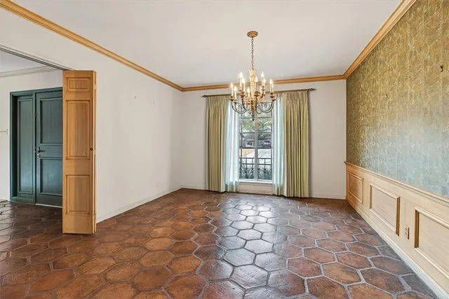 a view of a hallway with windows and chandelier