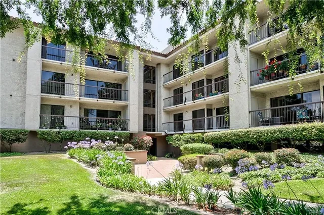 a front view of a residential apartment building with a yard