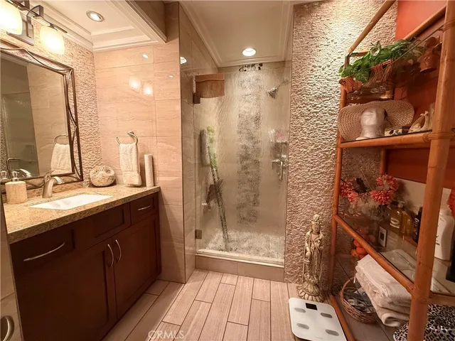 a bathroom with a double vanity sink toilet and shower