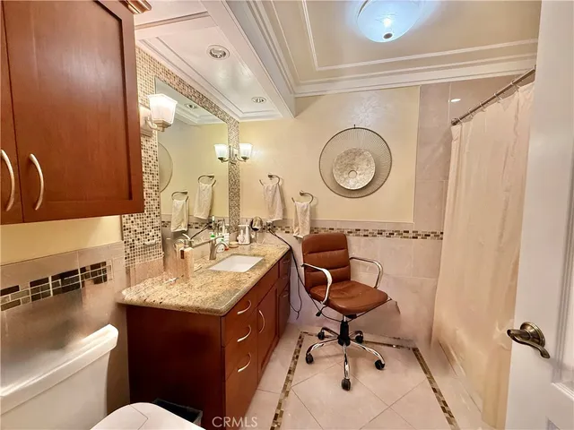 a bathroom with a toilet a sink and a mirror