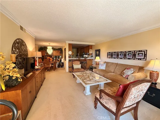 a living room with furniture a couch and a stove