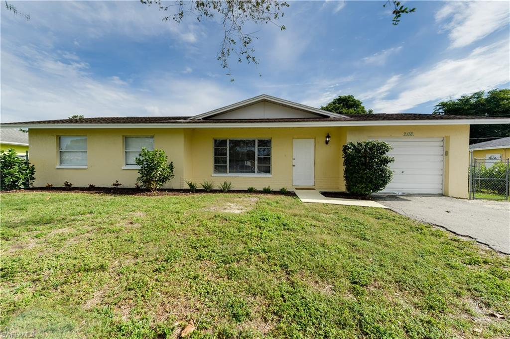 front view of house with potted plants