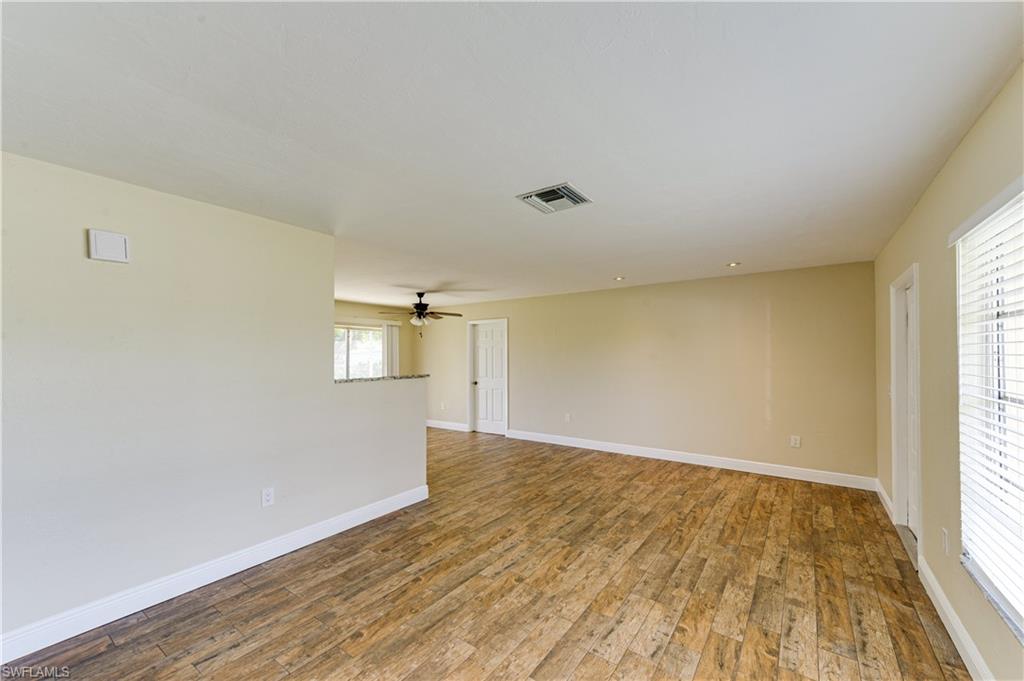 Undisclosed Address Naples, FL 34116 - Photo 18 of 18 an empty room with wooden floor and windows