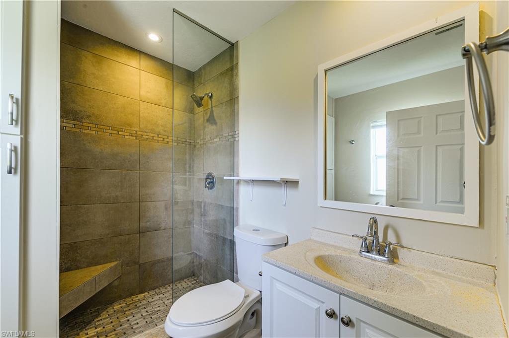 Undisclosed Address Naples, FL 34116 - Photo 11 of 18 a bathroom with a sink a toilet and shower