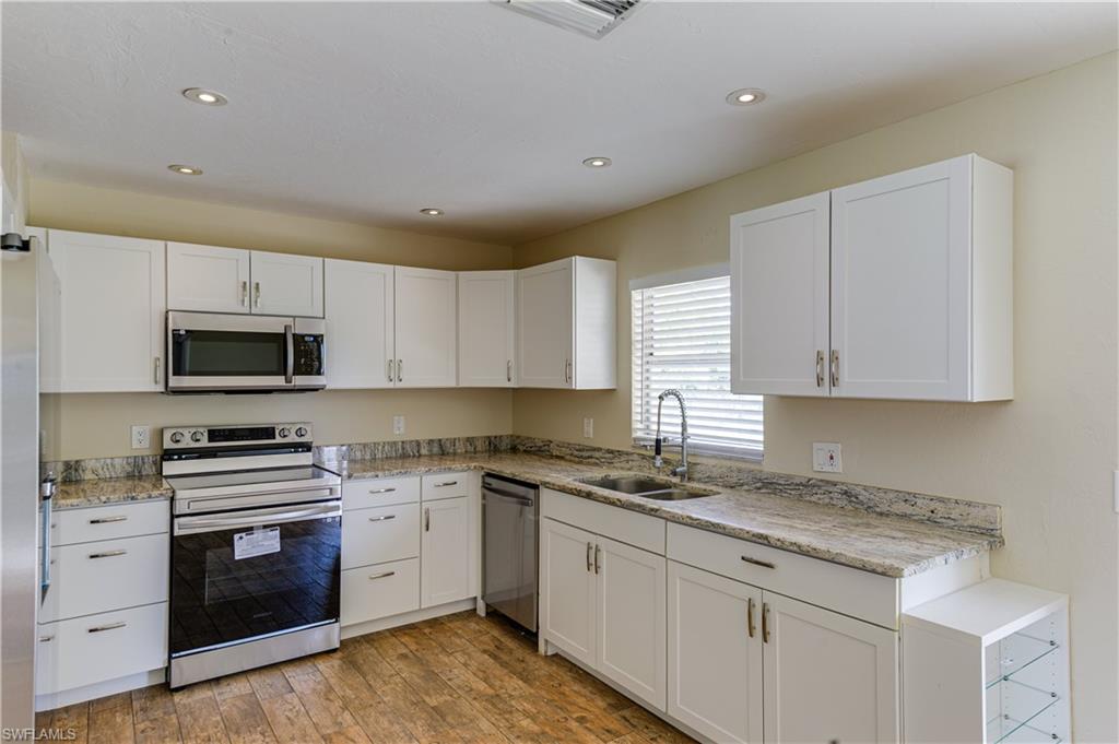 Undisclosed Address Naples, FL 34116 - Photo 7 of 18 a kitchen with cabinets stainless steel appliances and a counter space