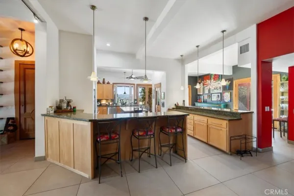 a kitchen with stainless steel appliances kitchen island granite countertop a stove a sink and a refrigerator