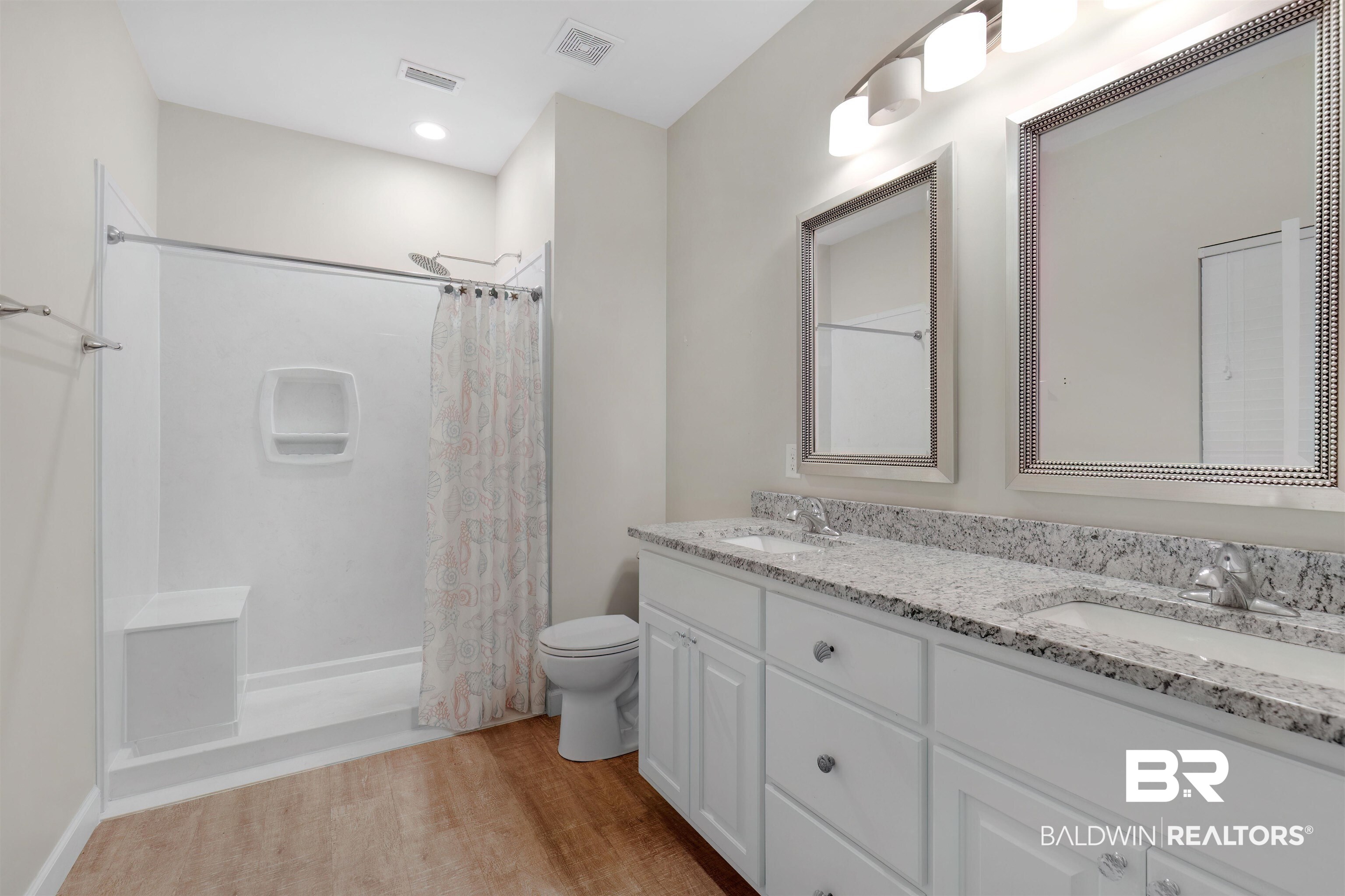 5625 Georgia Street Orange Beach, AL 36561 - Photo 22 of 30 Full bathroom with toilet, vanity, shower / bath combo, and hardwood / wood-style floors