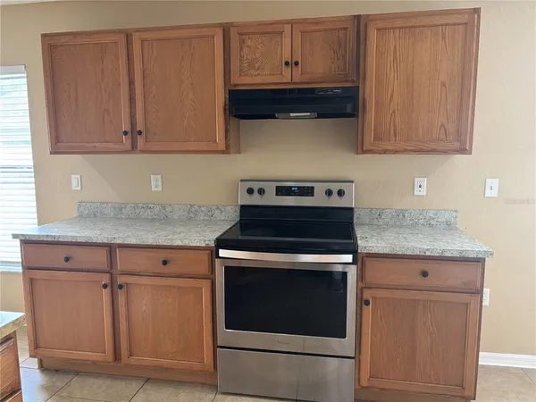 a kitchen with granite countertop cabinets and stainless steel appliances