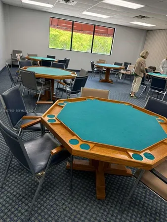 a room with furniture pool table and a view of living room