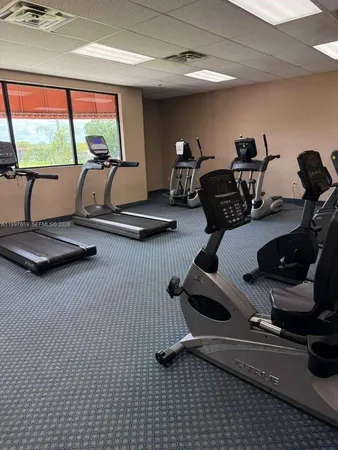 a room with gym equipment and a large window