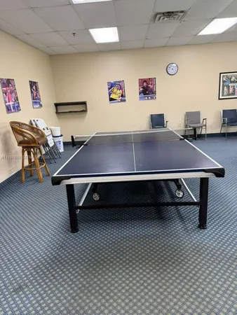 a room with furniture pool table and table tennis