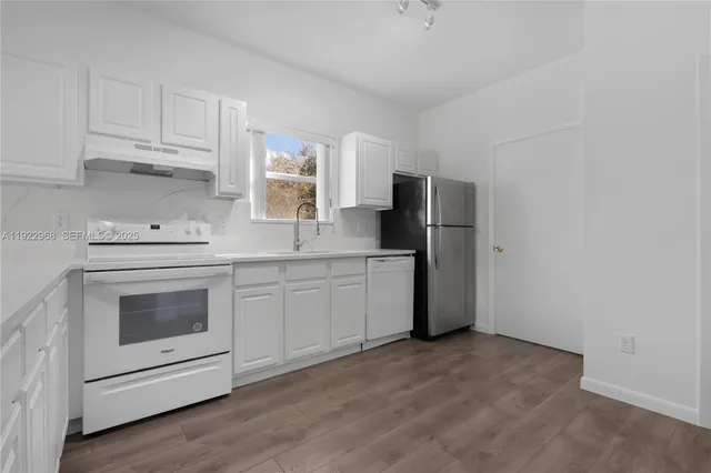 a kitchen with a refrigerator and cabinets