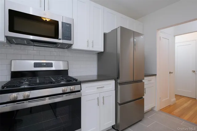 a kitchen with stainless steel appliances a refrigerator stove and microwave