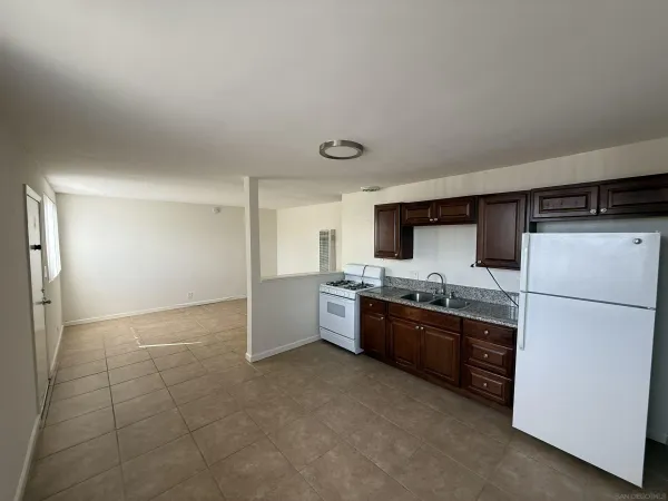 a large kitchen with cabinets and stainless steel appliances