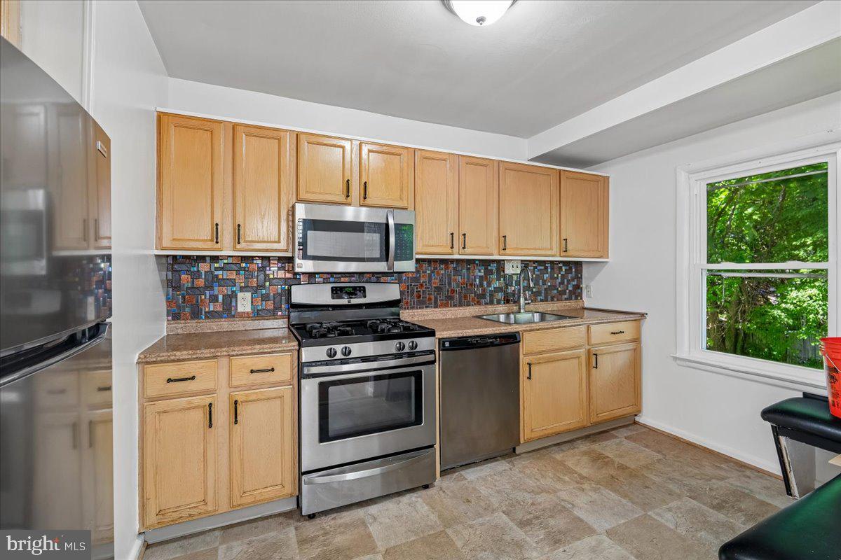 13012 Georgia Avenue Silver Spring, MD 20906 - Photo 10 of 31 Modern kitchen with vibrant backsplash.
