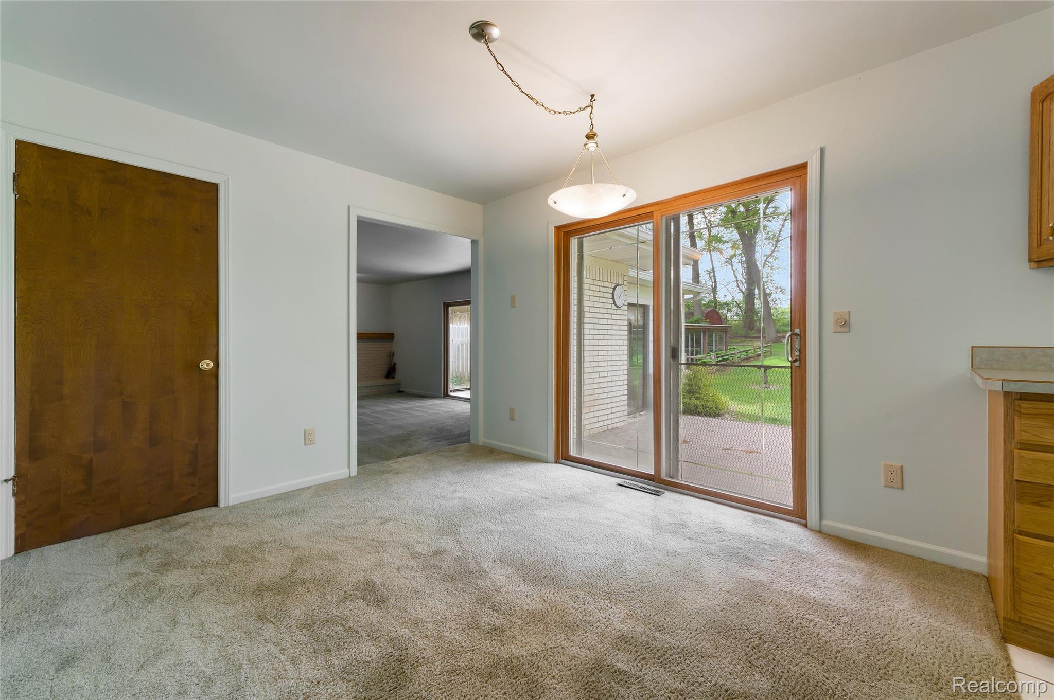 8887 Clark Road Clarkston, MI 48346 - Photo 8 of 40 Unfurnished dining area with healthy amount of natural light and light carpet