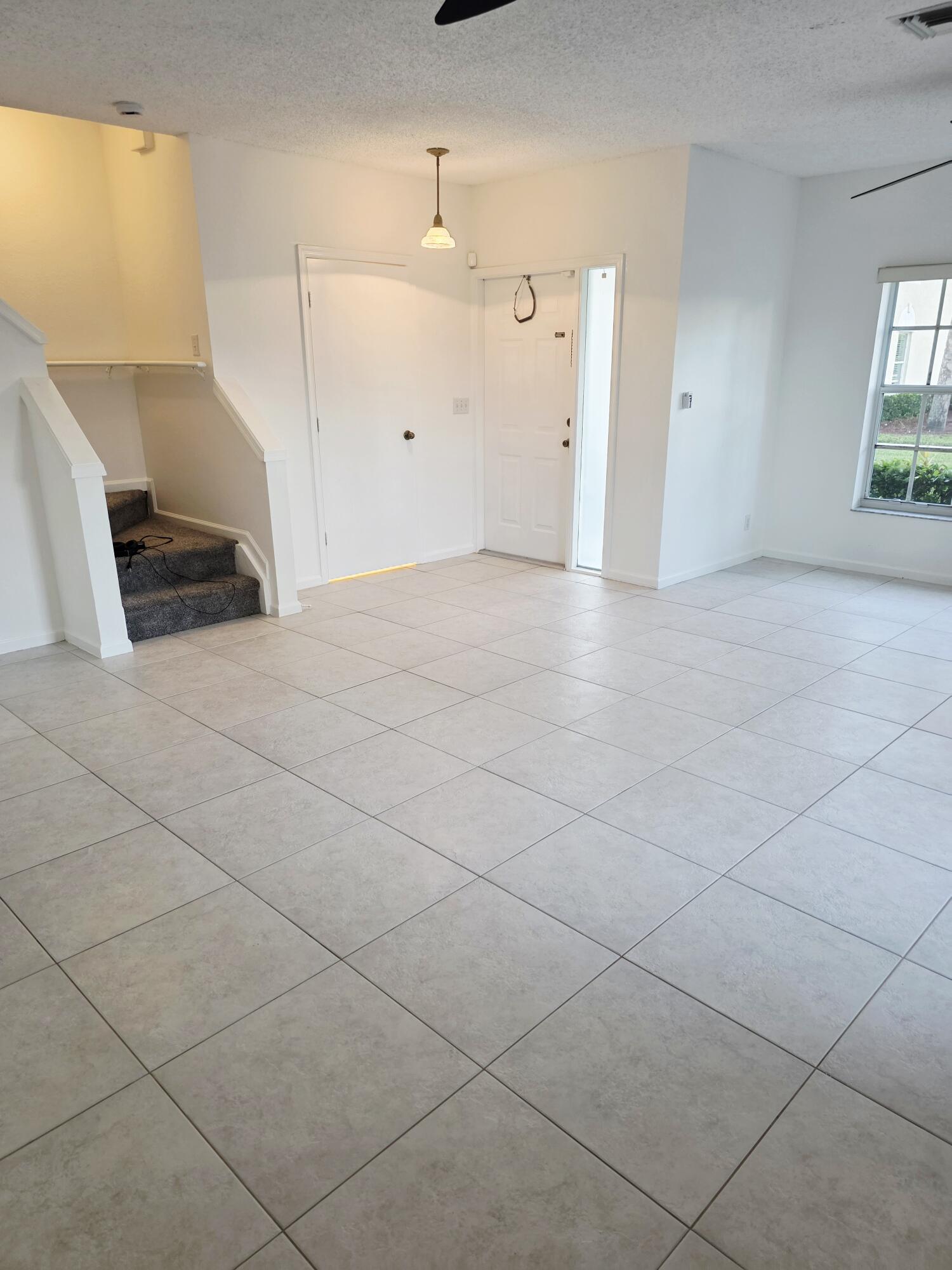 10851 Palm Ridge Lane Tamarac, FL 33321 - Photo 12 of 40 an empty room with windows and entrance