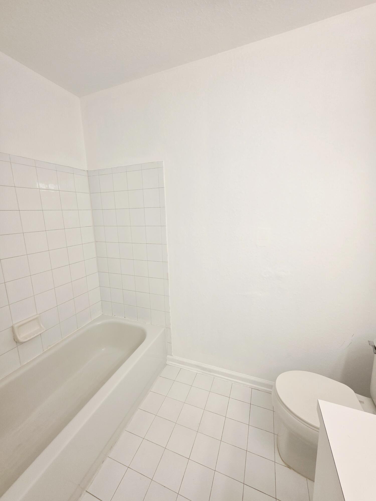 10851 Palm Ridge Lane Tamarac, FL 33321 - Photo 16 of 40 a spacious bathroom with a bathtub and toilet