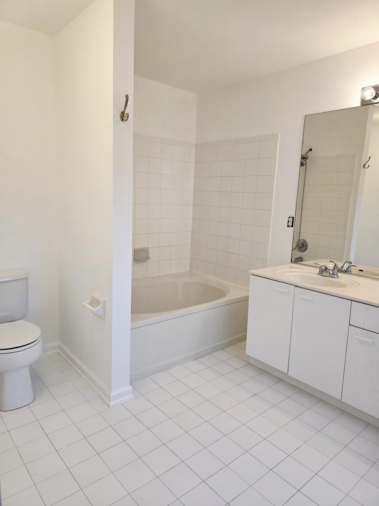 10851 Palm Ridge Lane Tamarac, FL 33321 - Photo 23 of 40 a bathroom with a bathtub sink and toilet