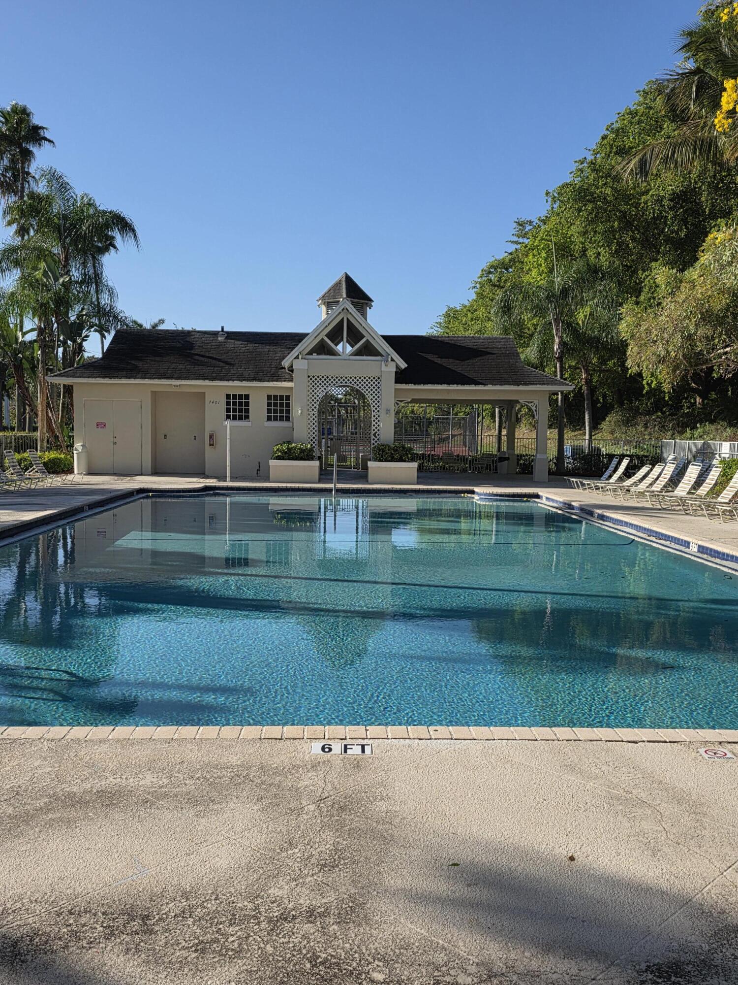 10851 Palm Ridge Lane Tamarac, FL 33321 - Photo 31 of 40 a front view of a house with a yard