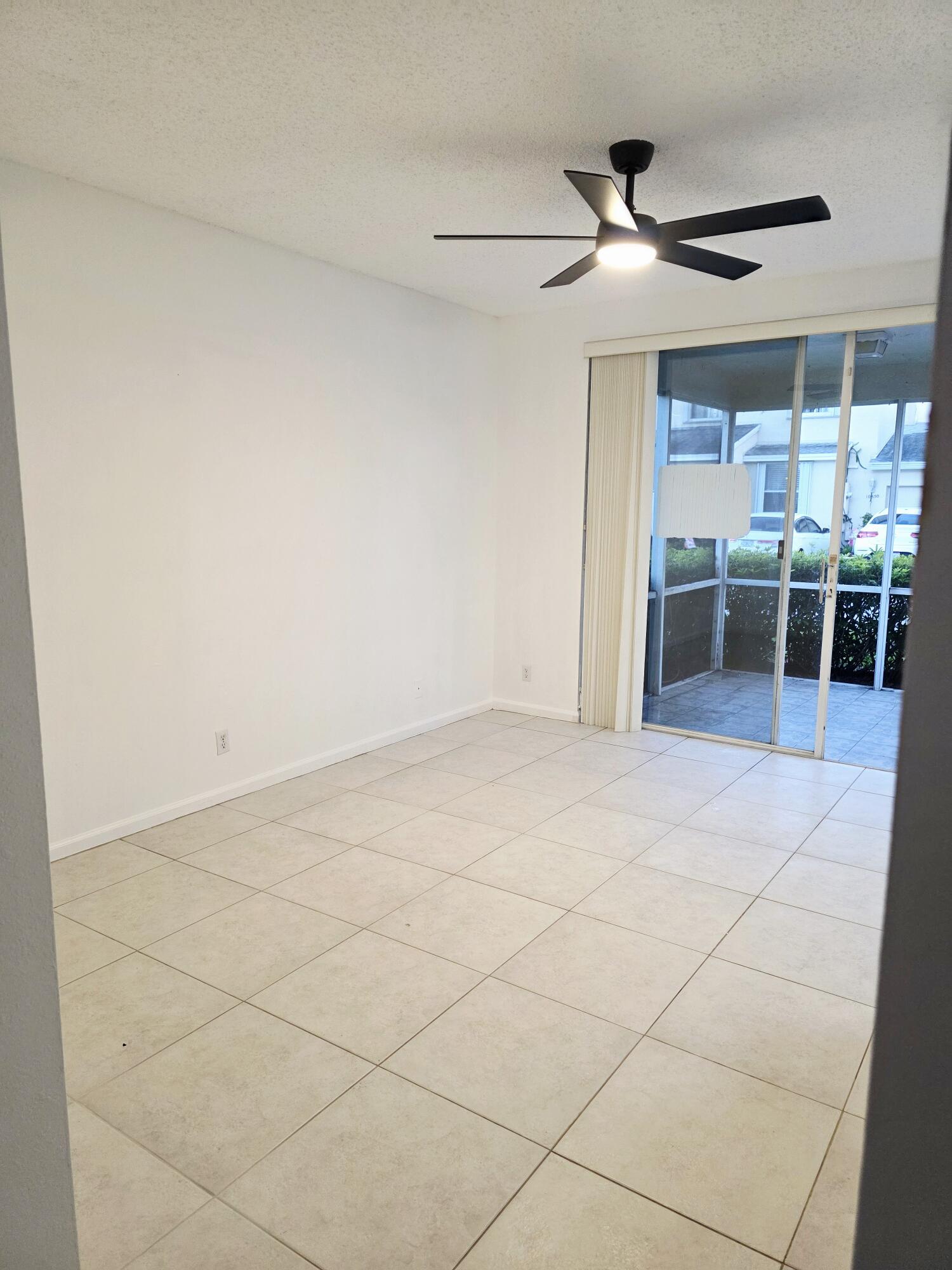 10851 Palm Ridge Lane Tamarac, FL 33321 - Photo 9 of 40 a view of a livingroom with a ceiling fan and window