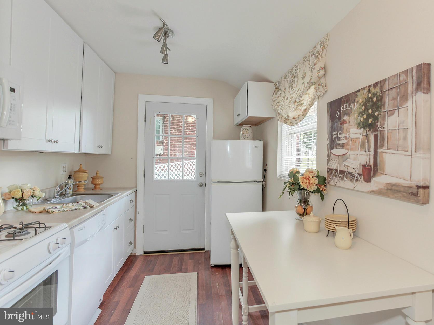 3005 Weisman Road Silver Spring, MD 20902 - Photo 9 of 29 a kitchen with a sink stove and cabinets