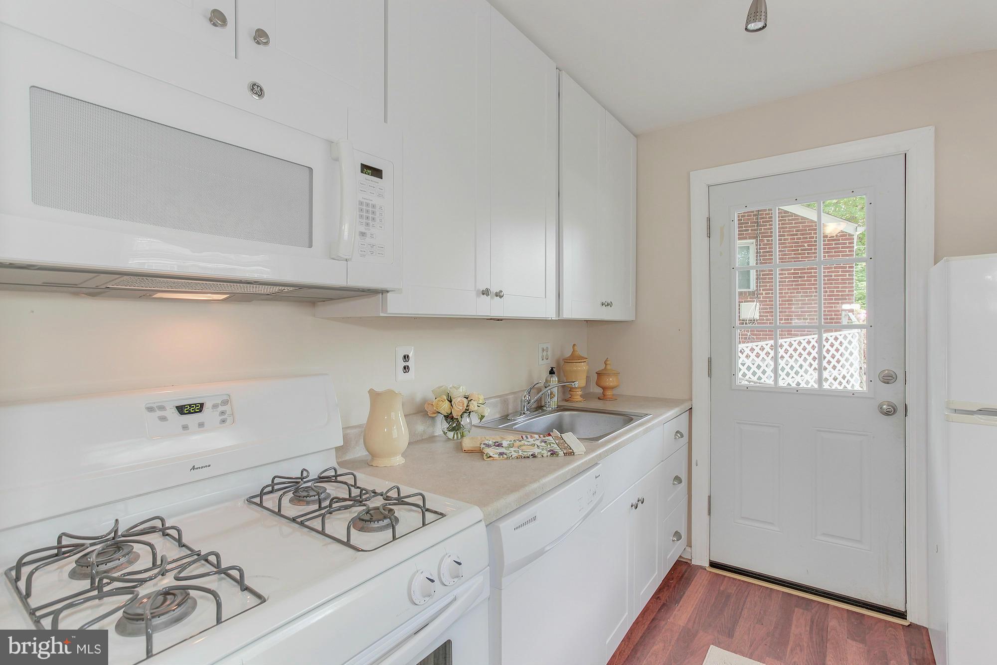 3005 Weisman Road Silver Spring, MD 20902 - Photo 10 of 29 a kitchen with stainless steel appliances a white stove top oven and cabinets