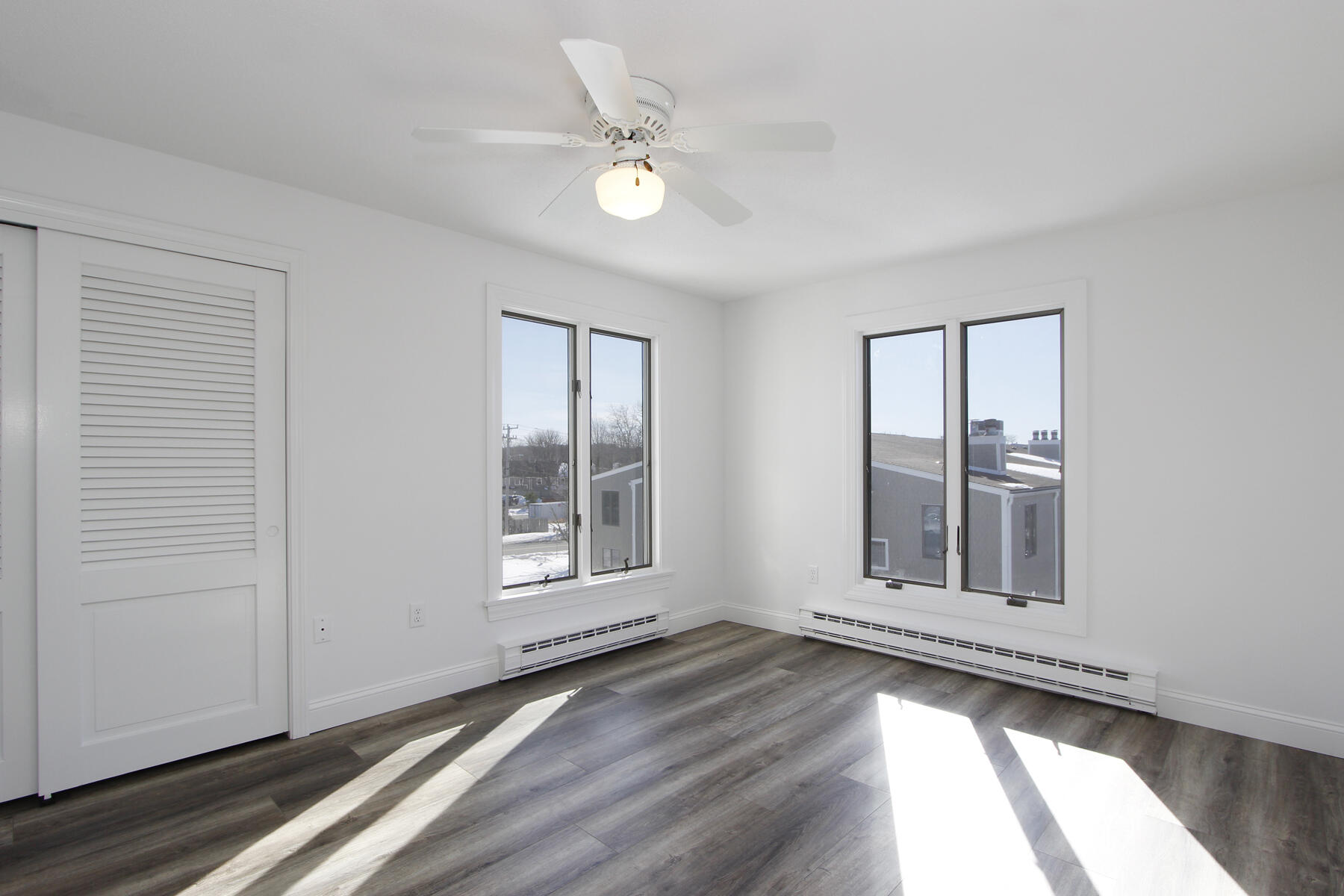 36 Old Colony Way, Unit 21 Orleans, MA 02653 - Photo 13 of 25 an empty room with wooden floor and windows