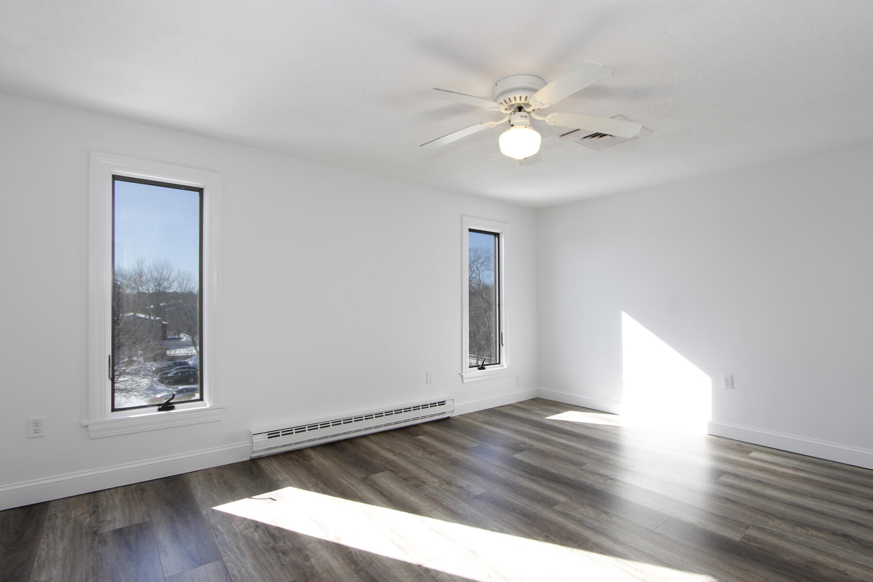 36 Old Colony Way, Unit 21 Orleans, MA 02653 - Photo 14 of 25 a view of an empty room with wooden floor and a window
