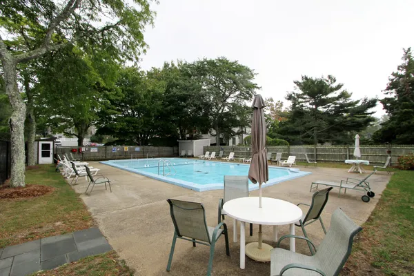 a swimming pool with outdoor seating and yard