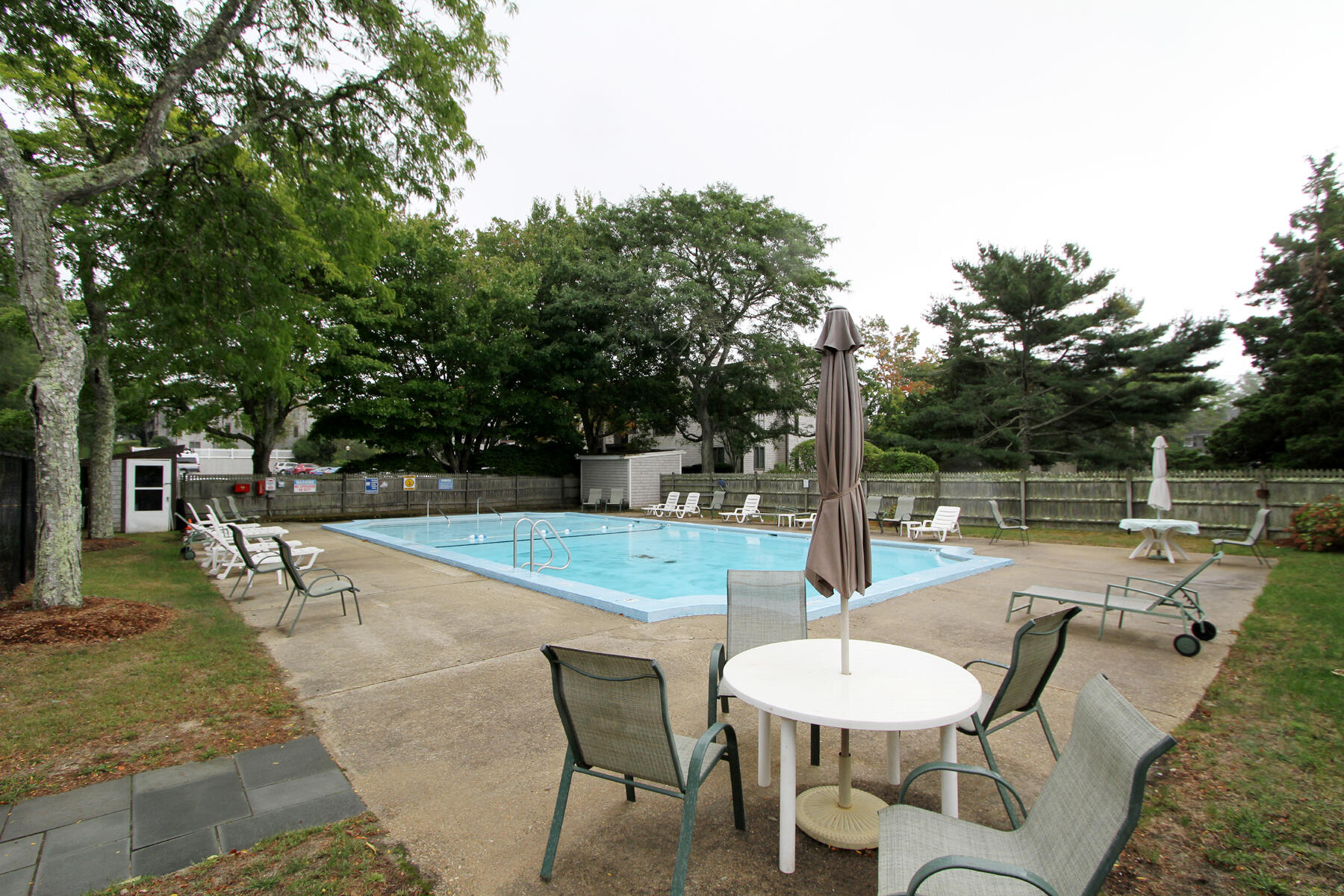 36 Old Colony Way, Unit 21 Orleans, MA 02653 - Photo 18 of 25 a swimming pool with outdoor seating and yard