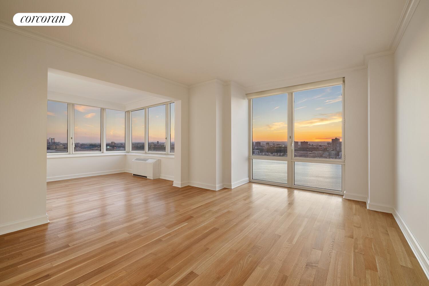 80 Riverside Boulevard, Unit 36B Manhattan, NY 10069 - Photo 4 of 25 an empty room with wooden floor and windows