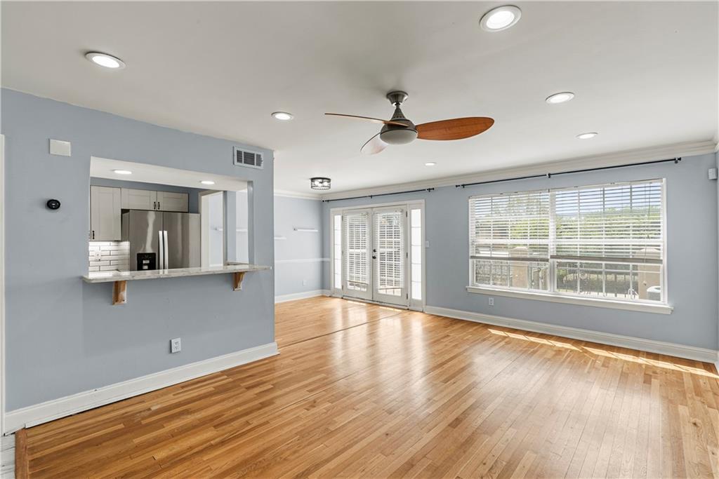 6980 Roswell Road, Unit K4 Atlanta, GA 30328 - Photo 12 of 31 a view of an empty room with a window and wooden floor