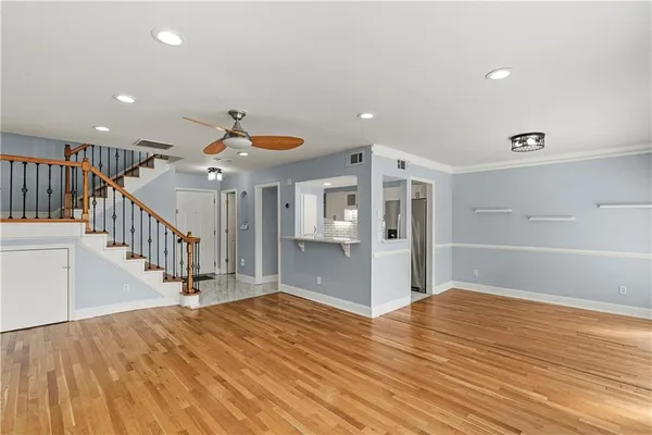 a view of a livingroom with wooden floor and white walls