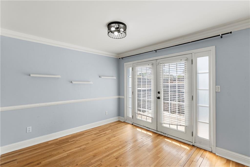 6980 Roswell Road, Unit K4 Atlanta, GA 30328 - Photo 15 of 31 a view of an empty room with wooden floor and a window