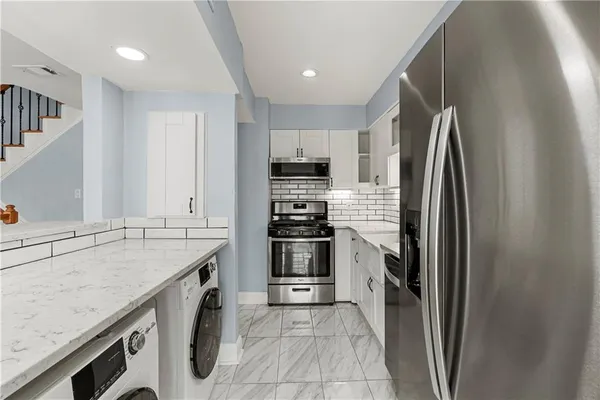 a kitchen with a sink stove and refrigerator
