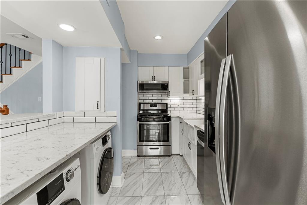 6980 Roswell Road, Unit K4 Atlanta, GA 30328 - Photo 16 of 31 a kitchen with a sink stove and refrigerator