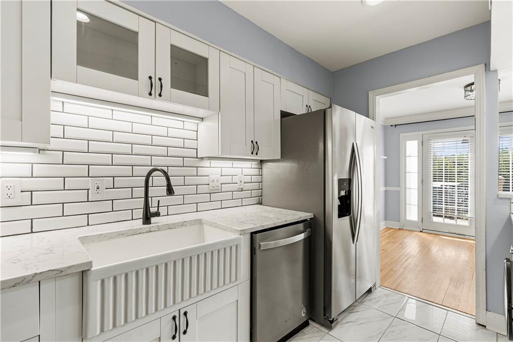 6980 Roswell Road, Unit K4 Atlanta, GA 30328 - Photo 19 of 31 a kitchen with stainless steel appliances granite countertop a refrigerator and a sink