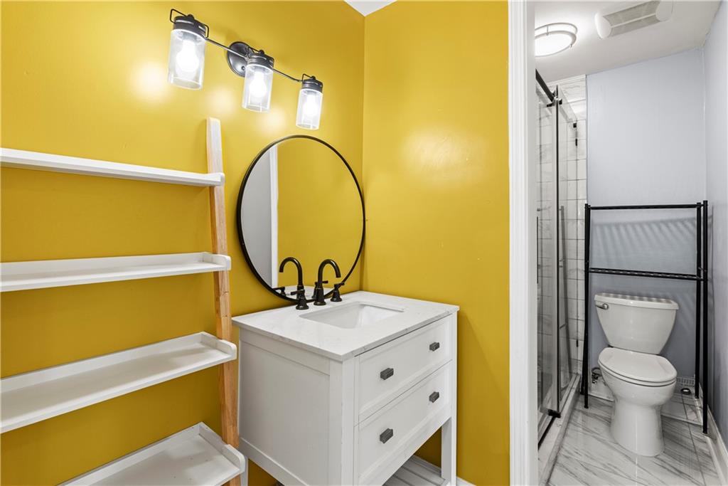 6980 Roswell Road, Unit K4 Atlanta, GA 30328 - Photo 20 of 31 a bathroom with a sink and a mirror