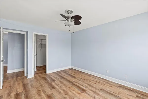a view of empty room with wooden floor