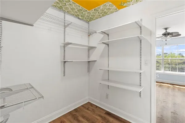 a view of walk in closet with empty racks