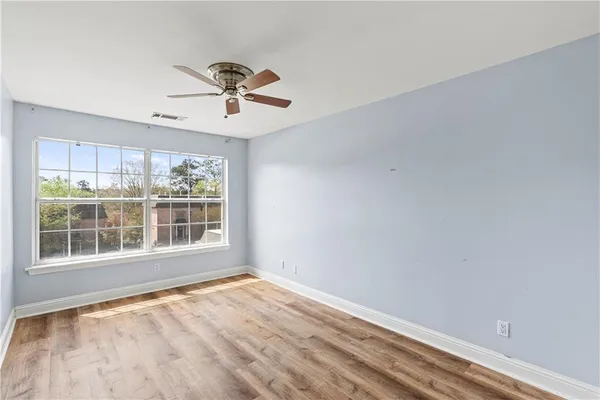wooden floor in an empty room with a window