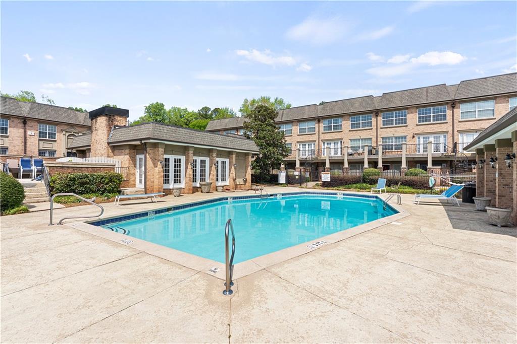 6980 Roswell Road, Unit K4 Atlanta, GA 30328 - Photo 6 of 31 a view of a swimming pool with a patio and a yard
